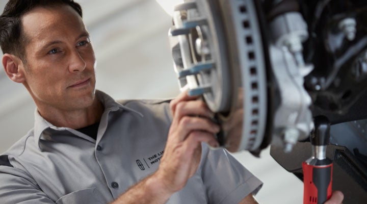 A mobile tech fixing brakes