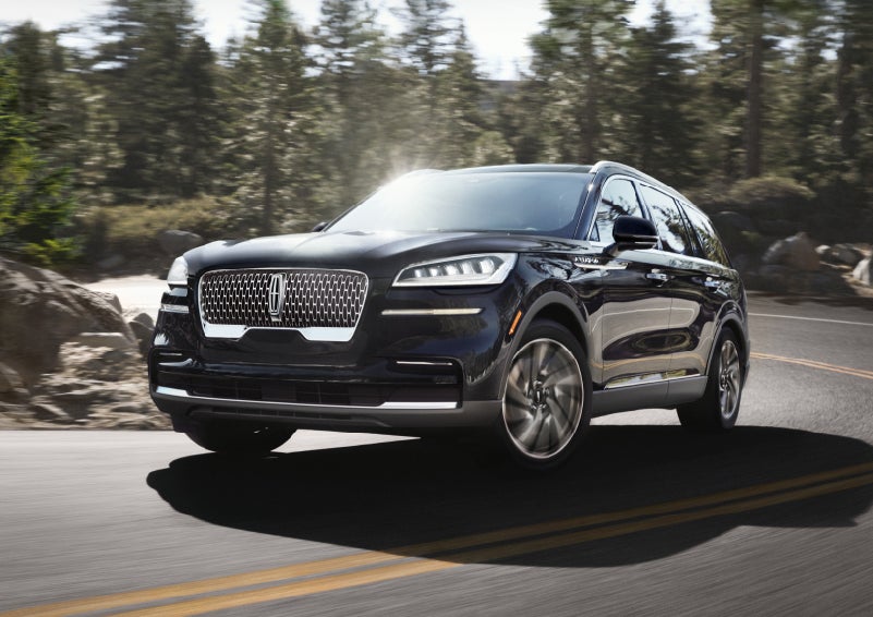 A Lincoln Aviator® SUV is being driven on a winding mountain road | Lincoln of Cutler Bay in Miami FL