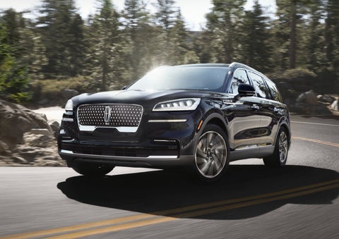 A Lincoln Aviator® SUV is being driven on a winding mountain road | Lincoln of Cutler Bay in Miami FL