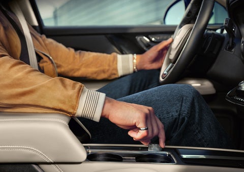 The driver of a 2025 Lincoln Corsair® SUV is shown selecting the Drive mode.