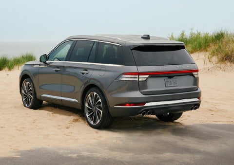 A 2027 Lincoln Aviator® SUV is parked next to sand dunes. | Lincoln of Cutler Bay in Miami FL