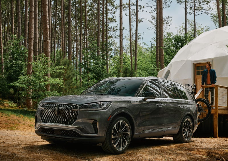 A 2027 Lincoln Aviator® is parked next to a high end glamping site. | Lincoln of Cutler Bay in Miami FL