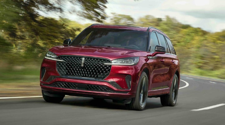 A 2027 Lincoln Aviator® SUV is being driven on a country road | Lincoln of Cutler Bay in Miami FL