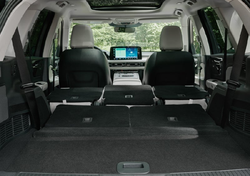 A rear to front view of the interior of a 2027 Lincoln Aviator® Black Label™ SUV shows the third and second rows folded flat | Lincoln of Cutler Bay in Miami FL